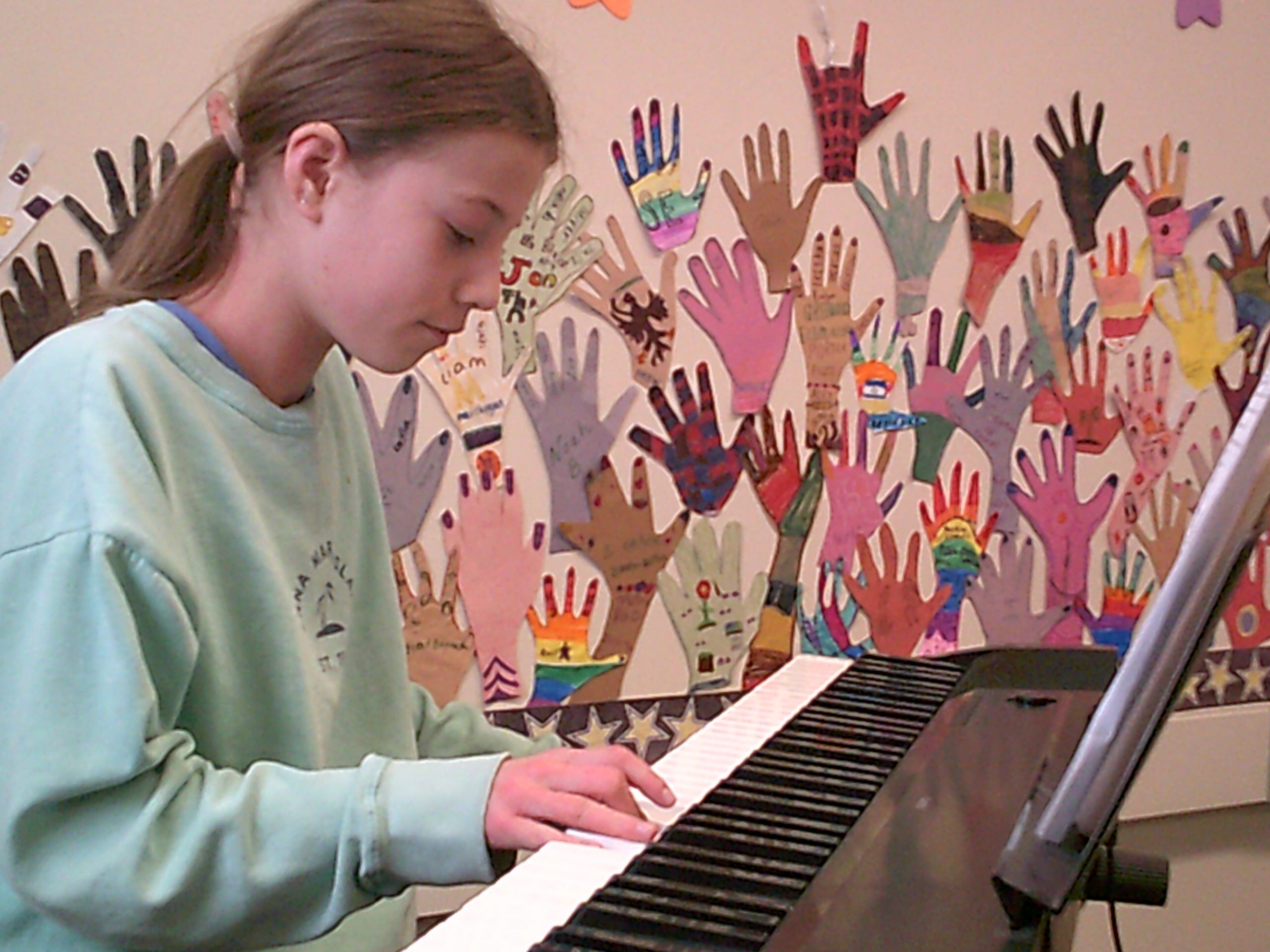 A student plays the keyboard during Song Writing Club.